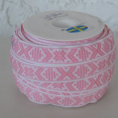 White ribbon with pale pink pattern sold by yard