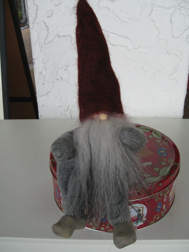 Sitting Vättetomte with red hat and sheepsking vest, movable arms and legs, wooden clogs, 14" tall, handmade by "Gnesta Tomten", Sweden